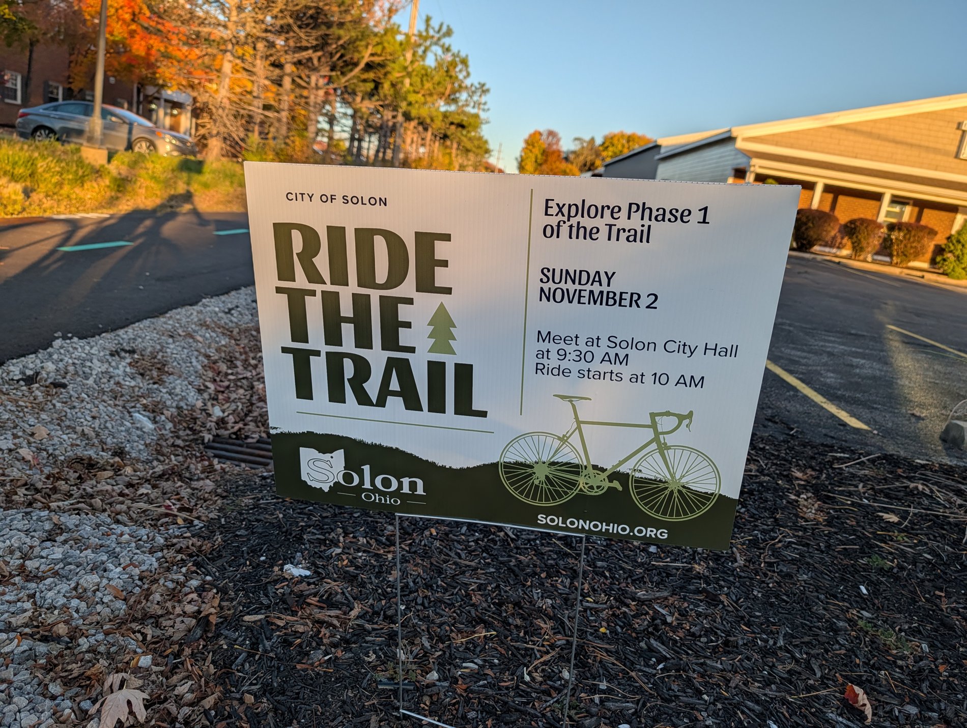 A City of Solon yard sign reading Ride the Trail, Explore Phase 1 of the Trail, Sunday November 2, meet at Solon City Hall at 9:30am, ride starts at 10am